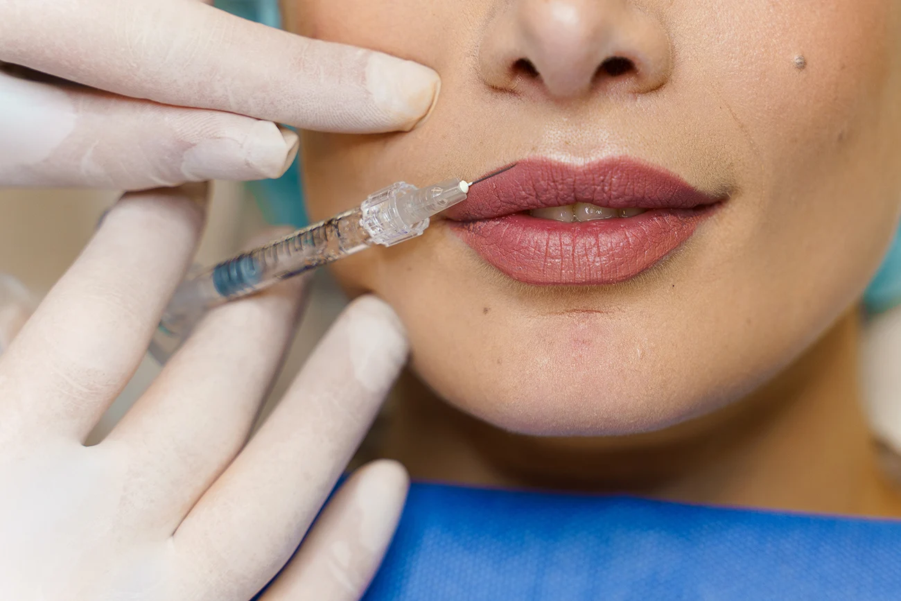 Close-up lips augmentation injections for attractive girl