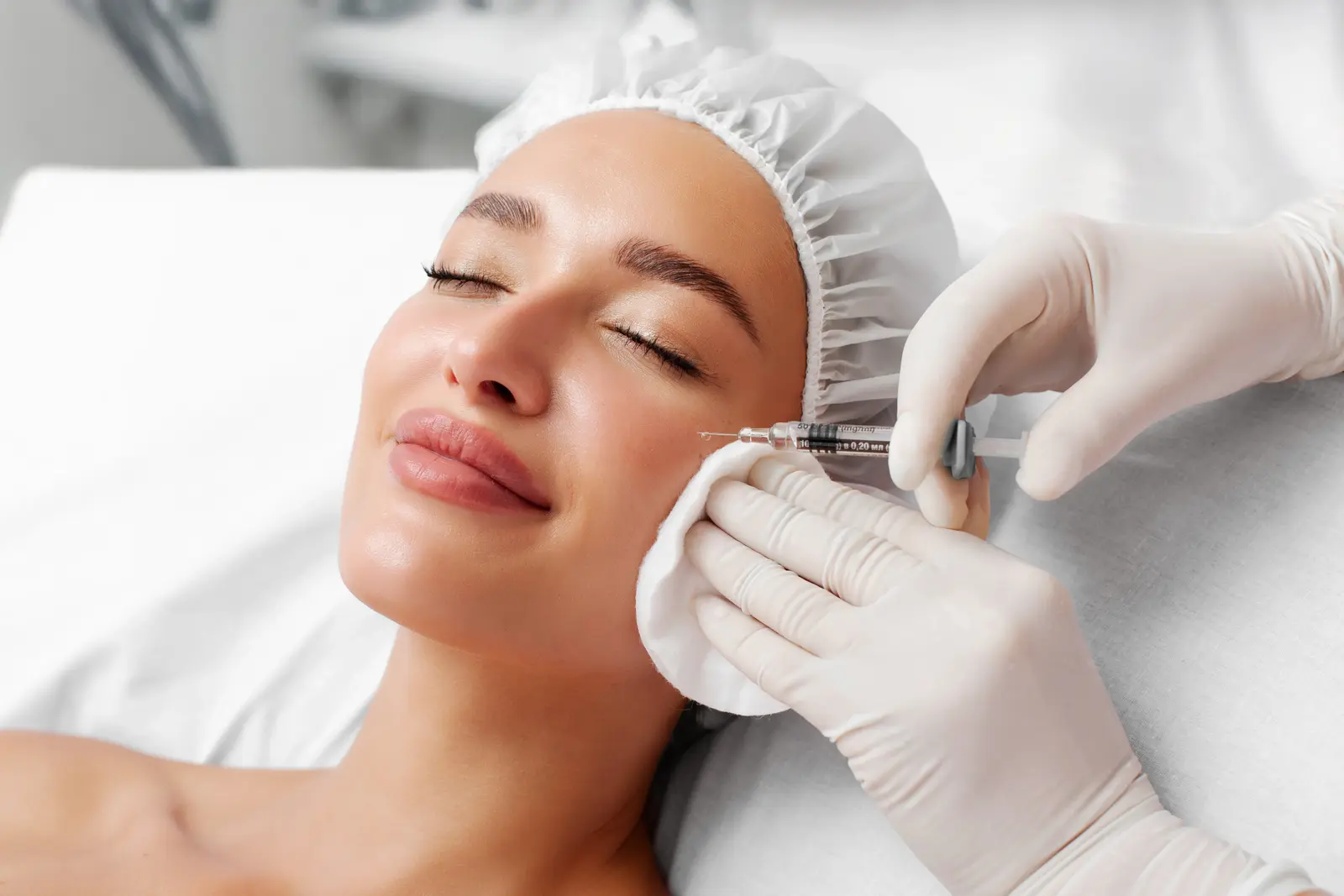 Woman receiving facial anti-aging treatment injection
